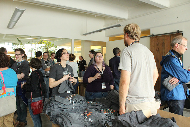 Attendees grabbing conference's t-shirts